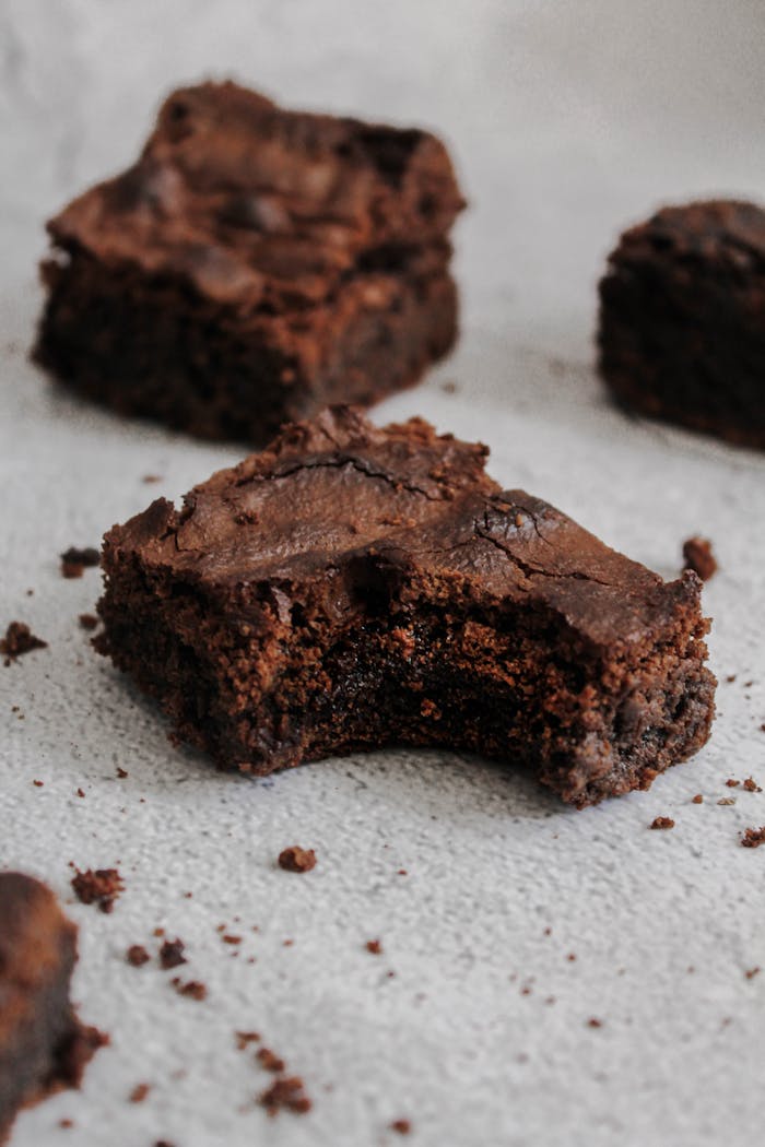 Indulge in rich chocolate brownies with a bite taken out, perfect for dessert lovers.